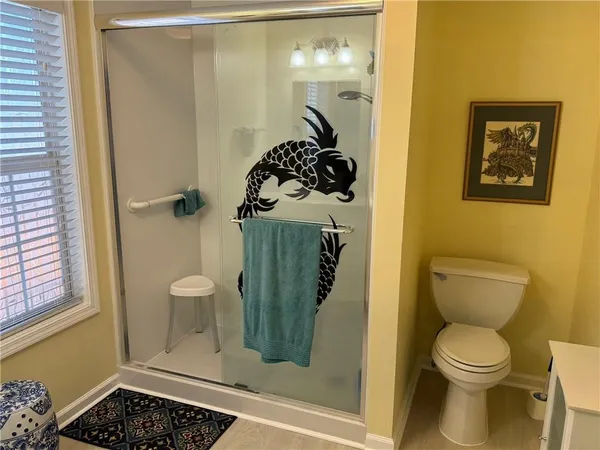 a bathroom with a toilet and a shower