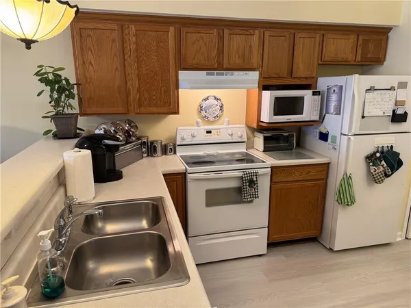 a kitchen with a stove microwave and refrigerator