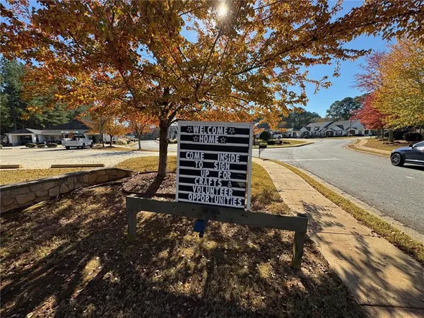 a view of a yard with wooden fence