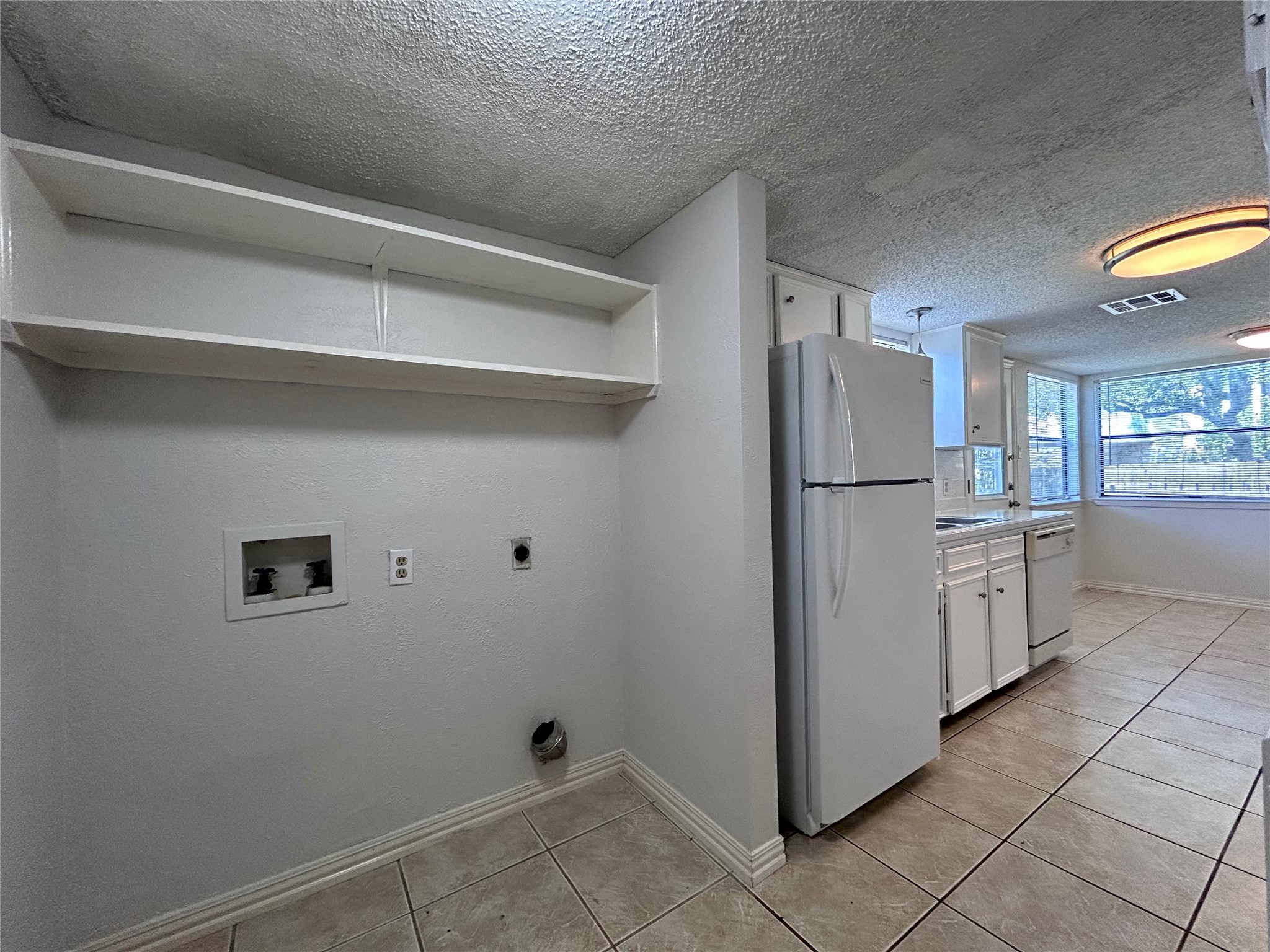 8800 Clearbrook Trail, Unit A Austin, TX 78729 - Photo 8 of 21 a kitchen with a refrigerator and a stove