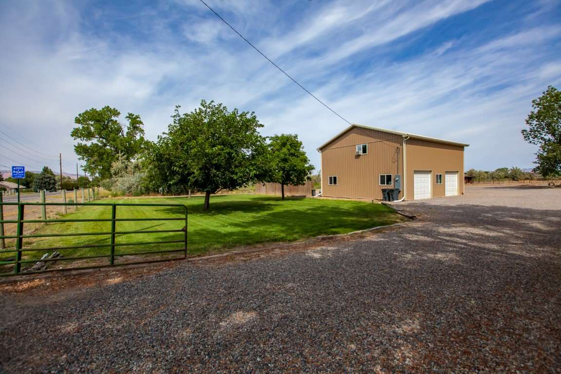 2390 H Road Grand Junction, CO 81505 - Photo 26 of 42 a front view of a house with a yard and garage