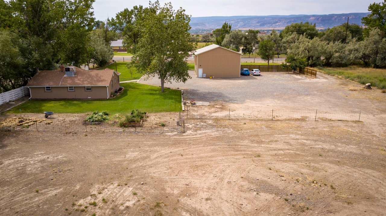 2390 H Road Grand Junction, CO 81505 - Photo 42 of 42 a view of a house with a yard and garage