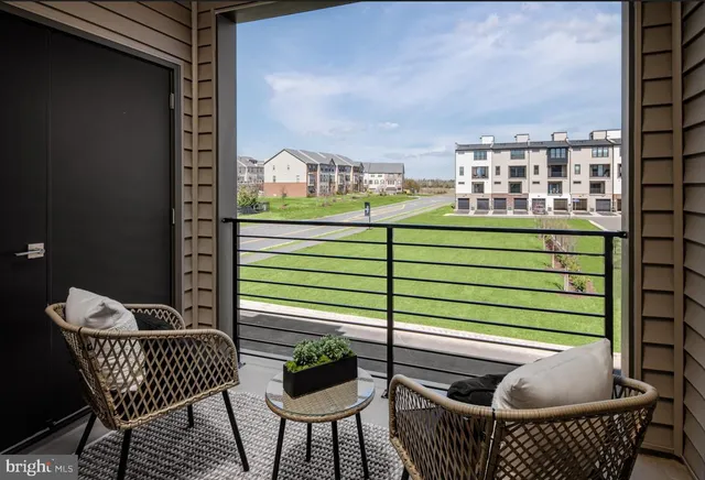 a balcony with table and chairs