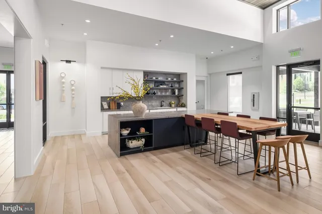 a living room with stainless steel appliances kitchen island granite countertop furniture and a kitchen view