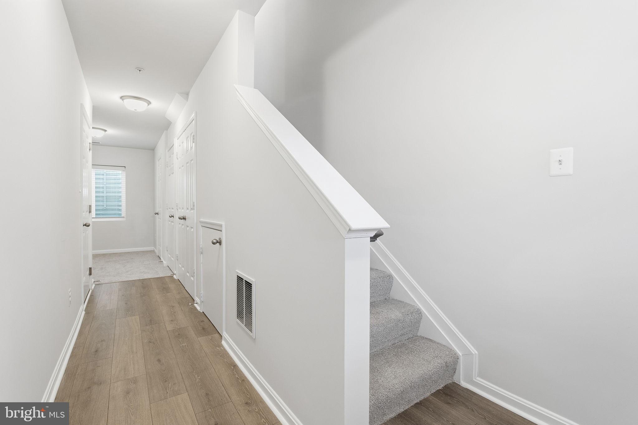 345 Tumblers Way, Unit 20 Joppa, MD 21085 - Photo 13 of 34 a view of a hallway with white walls and stairs