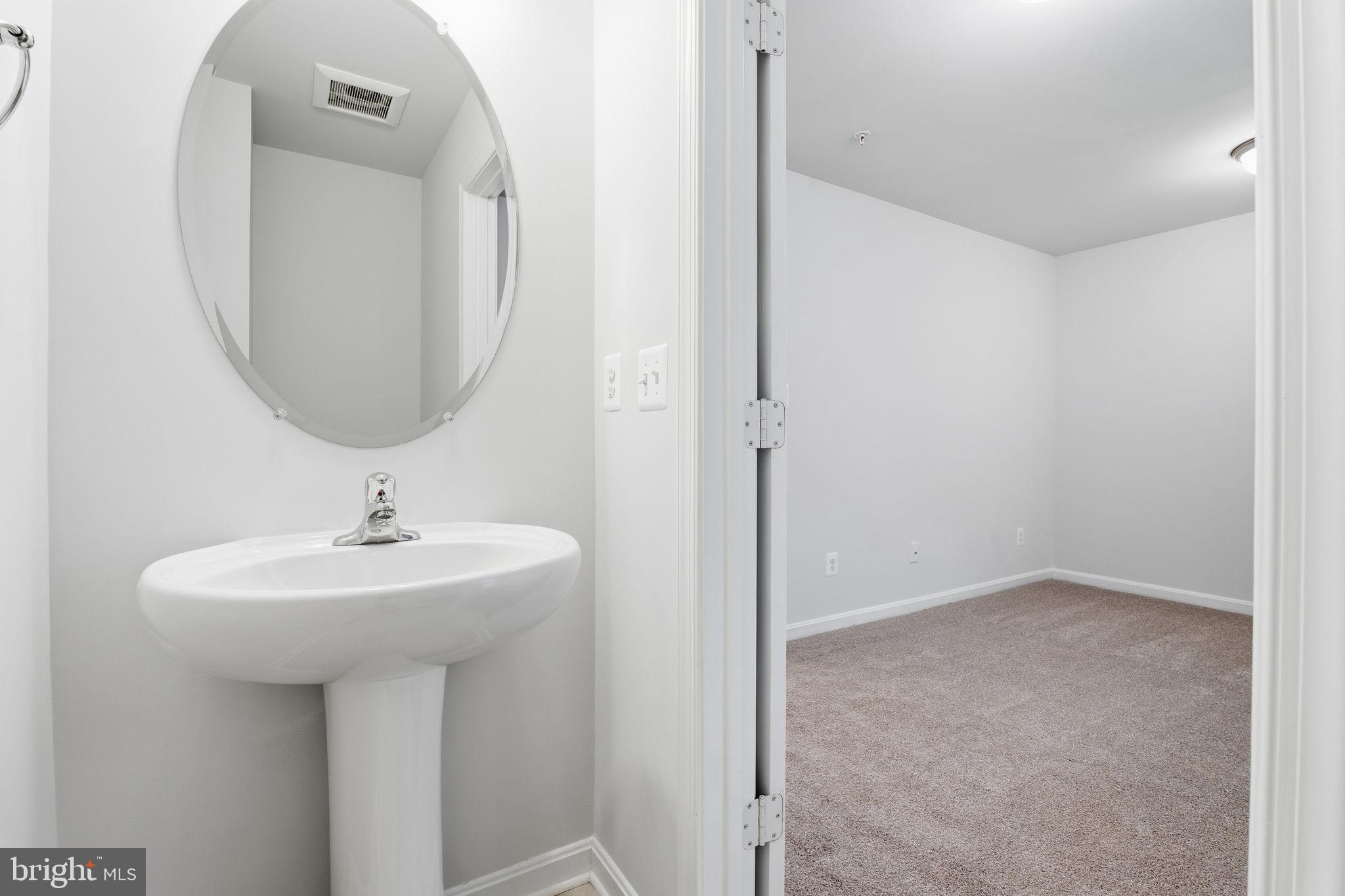 345 Tumblers Way, Unit 20 Joppa, MD 21085 - Photo 25 of 34 a bathroom with a sink and a mirror
