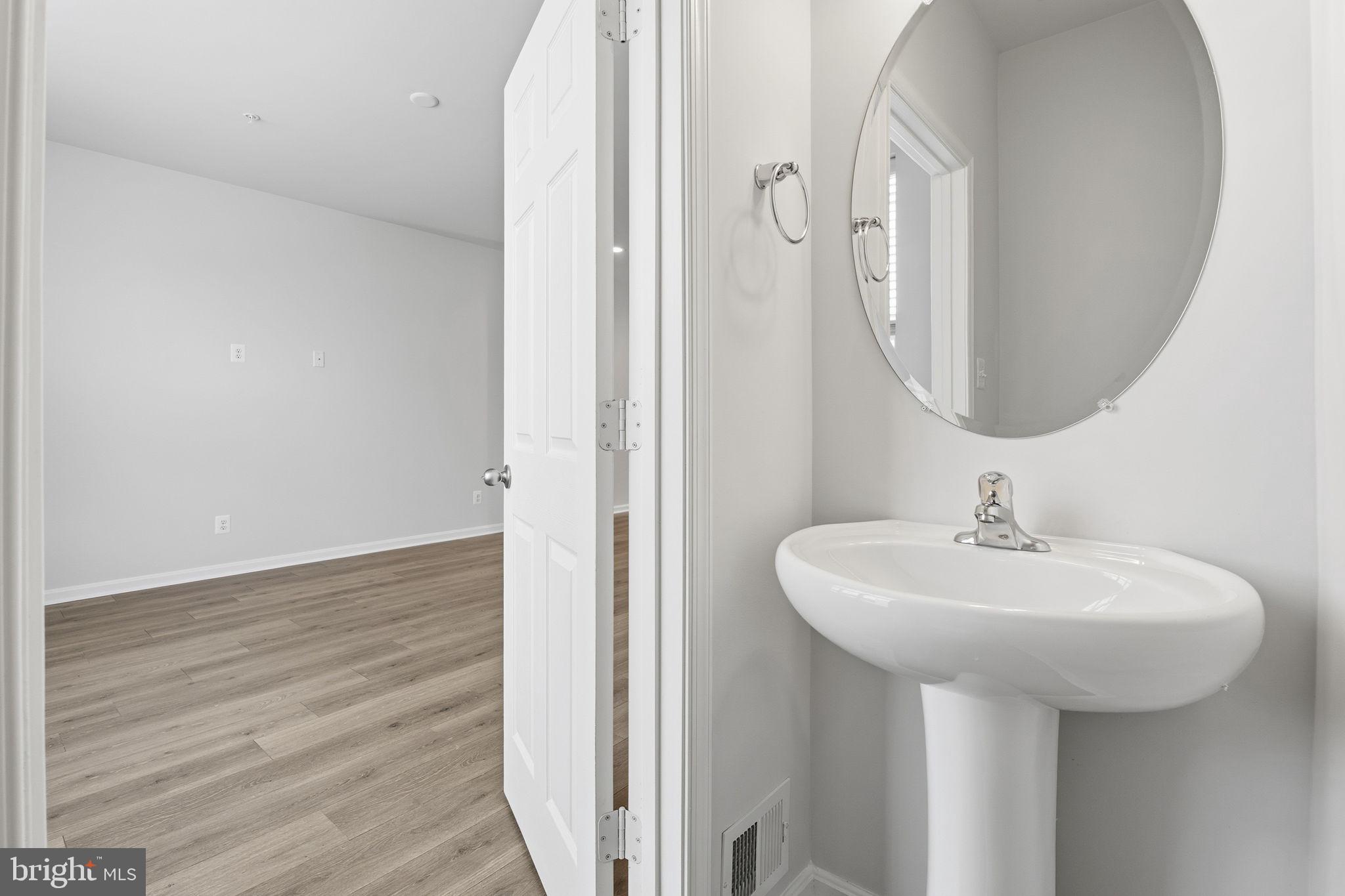 345 Tumblers Way, Unit 20 Joppa, MD 21085 - Photo 26 of 34 a bathroom with a sink and a mirror