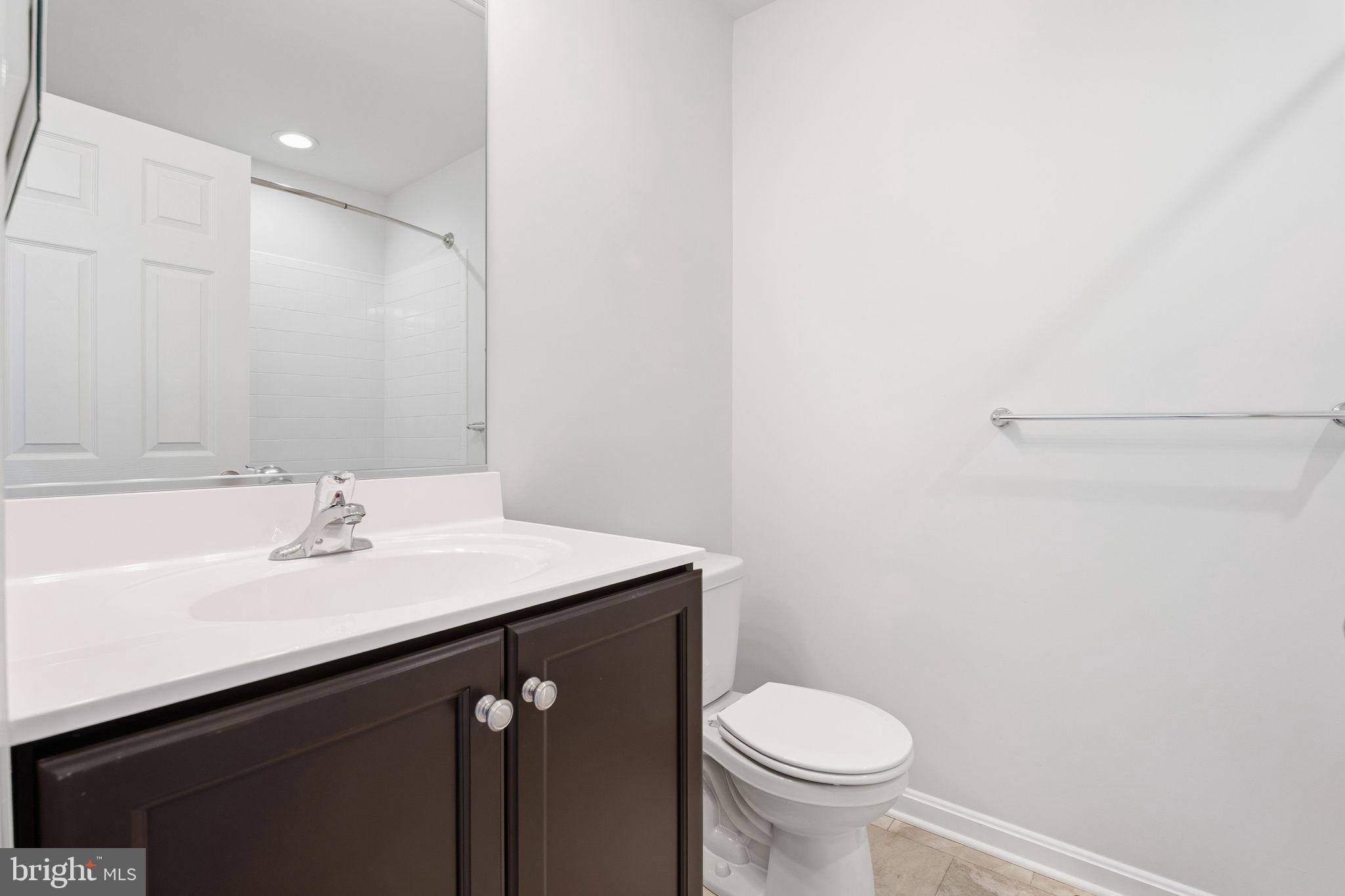 345 Tumblers Way, Unit 20 Joppa, MD 21085 - Photo 27 of 34 a bathroom with a sink a toilet and a mirror