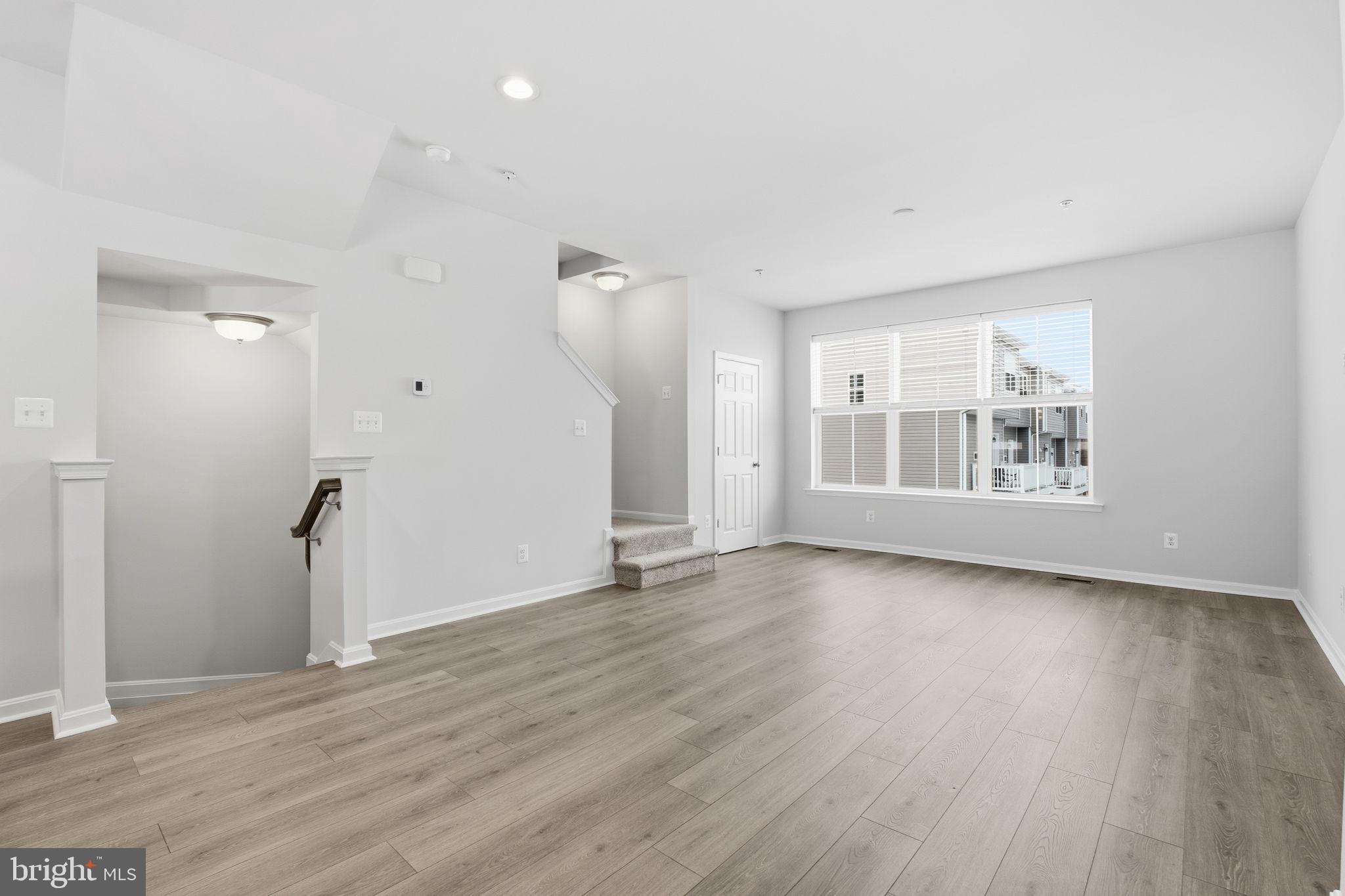 345 Tumblers Way, Unit 20 Joppa, MD 21085 - Photo 9 of 34 an empty room with wooden floor and windows