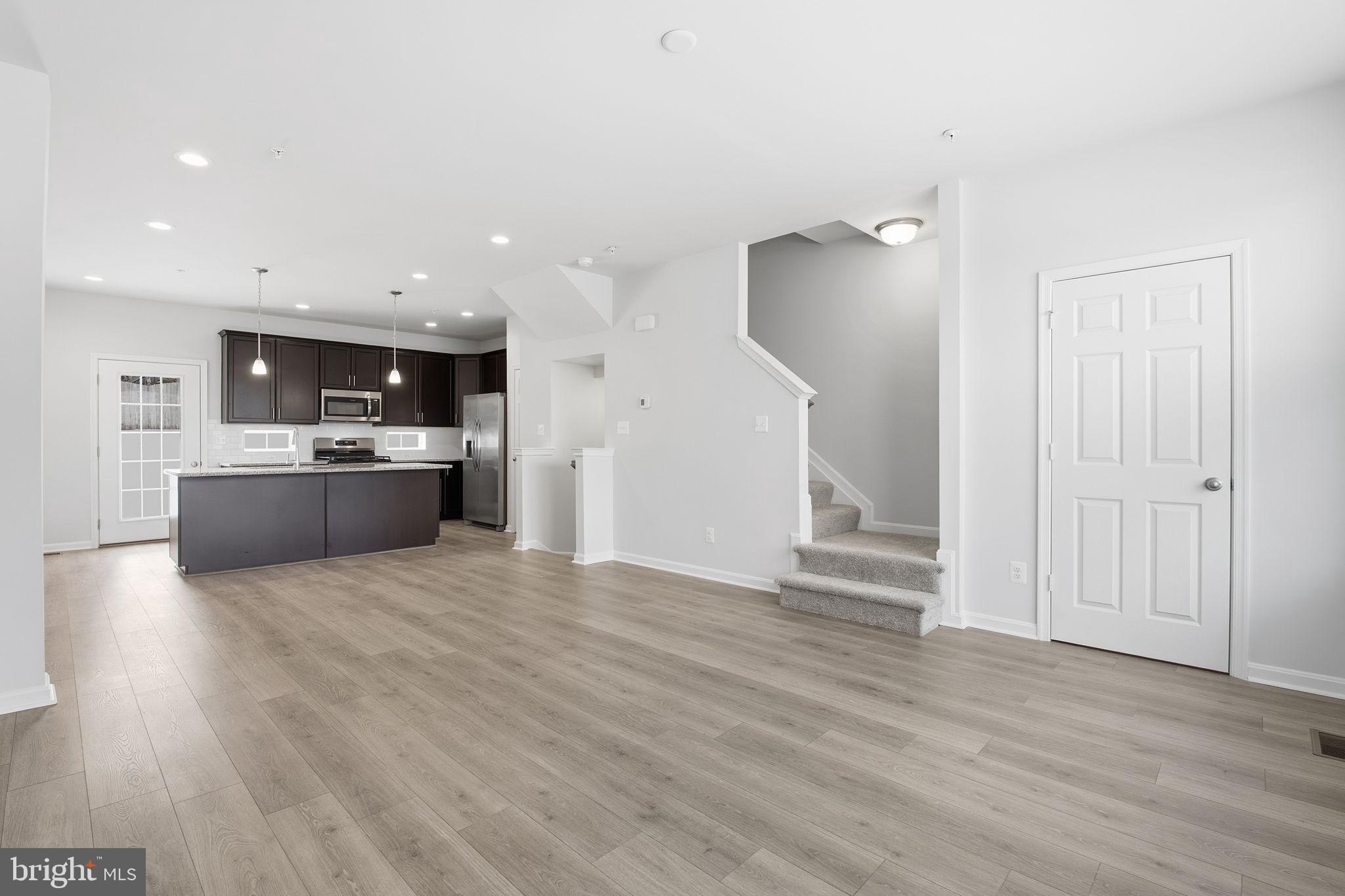 345 Tumblers Way, Unit 20 Joppa, MD 21085 - Photo 10 of 34 a view of kitchen and kitchen with furniture wooden floor and window