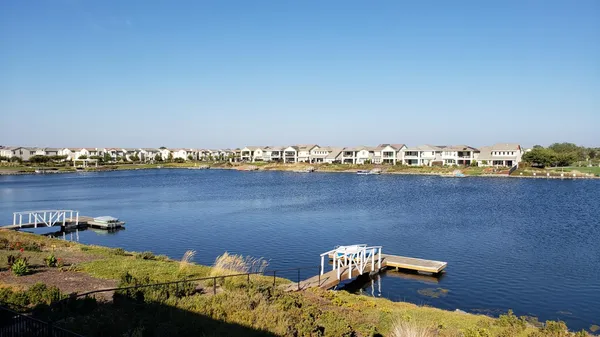 an aerial view of a houses with a lake