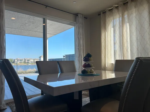 a view of a dining room with furniture and window