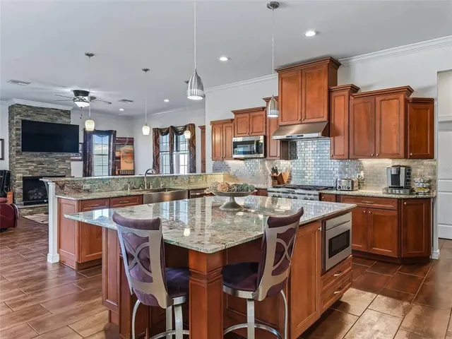 a kitchen with granite countertop a sink and appliances