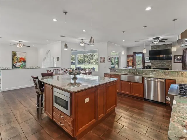 a kitchen with stainless steel appliances granite countertop a stove and a sink