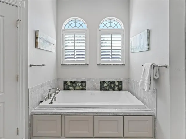 a bathroom with 2 sink and a window