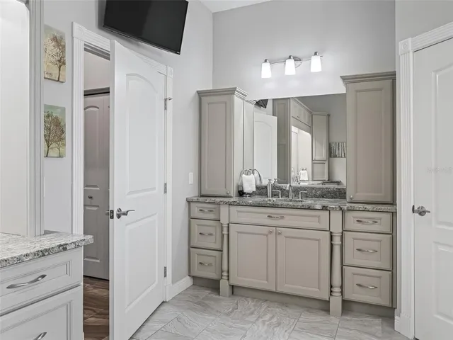 a bathroom with a granite countertop sink mirror and