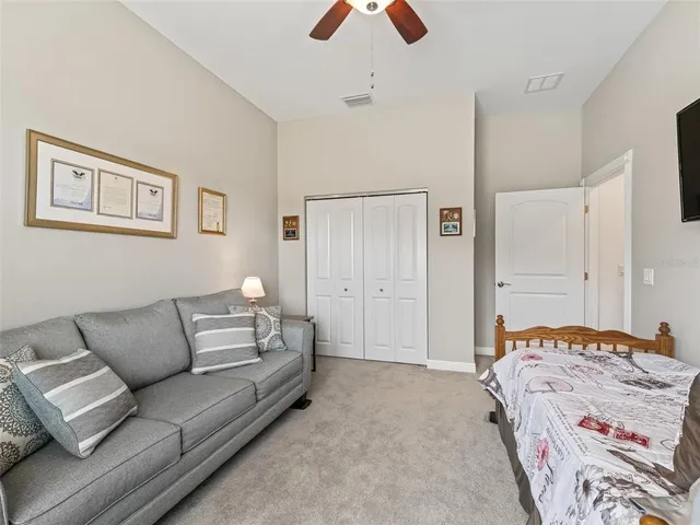 a bedroom with a bed and a couch