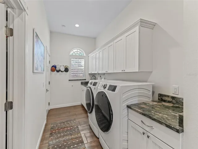 a utility room with sink dryer and washer