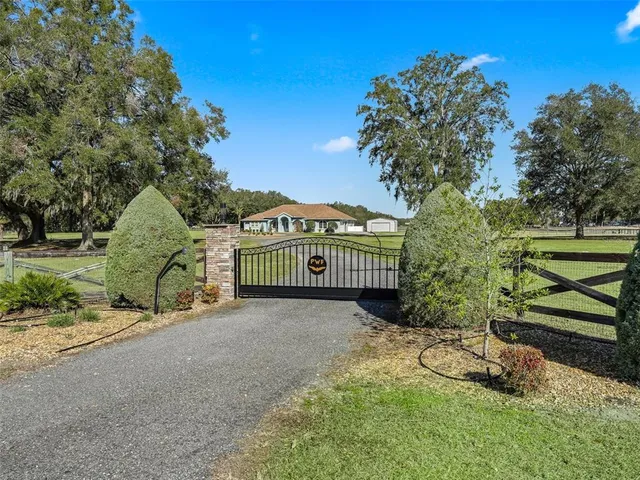 a view of a house with a yard and sitting area