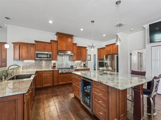 a kitchen with stainless steel appliances granite countertop a sink stove and refrigerator