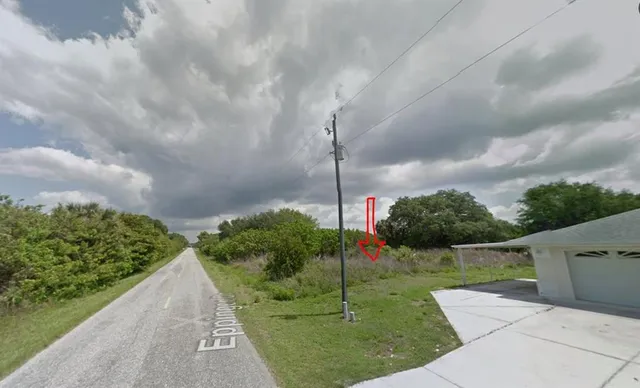an aerial view of a houses with yard