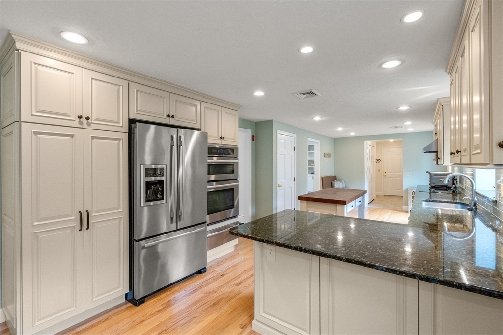 322 Concord Road Wayland, MA 01778 - Photo 4 of 35 a kitchen with stainless steel appliances granite countertop a refrigerator sink and stove