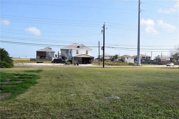 a view of a house with a big yard and potted plants