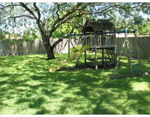 a view of backyard with deck and garden