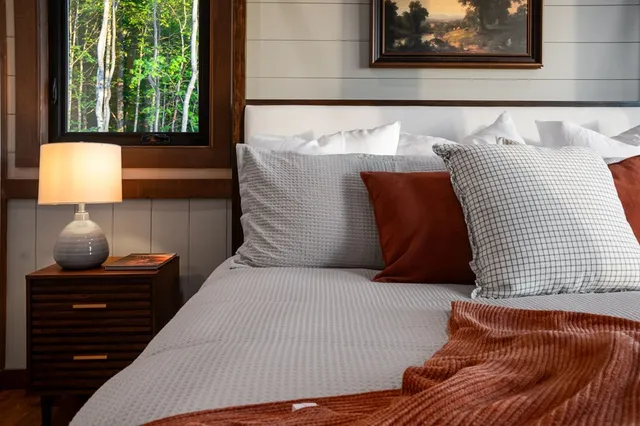 a bedroom with a large bed and a window