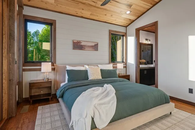 a view of a hallway with wooden floor and door