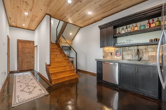 a bathroom with a granite countertop sink a toilet a mirror and shower