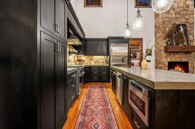 a kitchen with a stove a sink and a refrigerator
