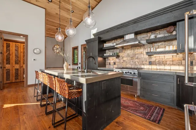 a view of a living room with water heater and wooden floor