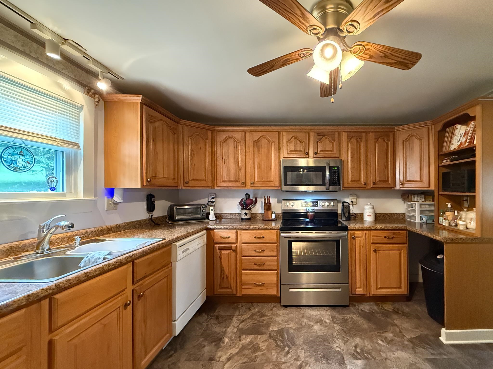 1249 Pounding Creek Road Charlottesville, VA 22903 - Photo 15 of 20 a kitchen with stainless steel appliances granite countertop a stove sink microwave and refrigerator