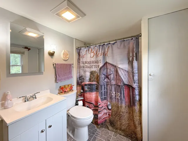 a bathroom with a sink toilet and shower