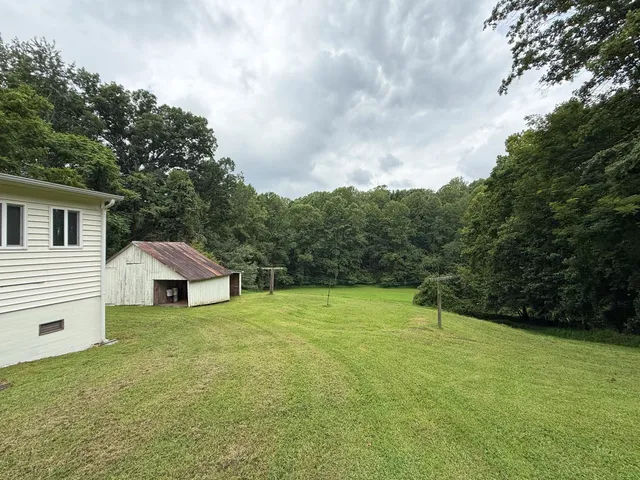 a backyard of a house with lots of green space