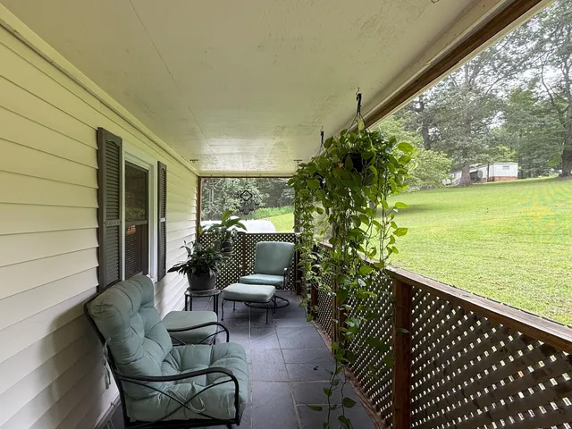 a balcony with furniture and a potted plant