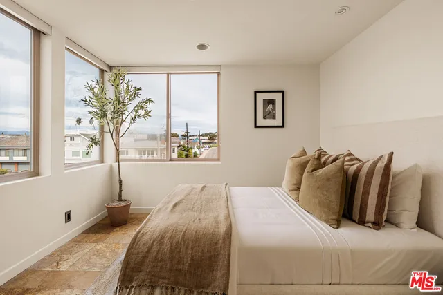 a bedroom with a large bed and a large window