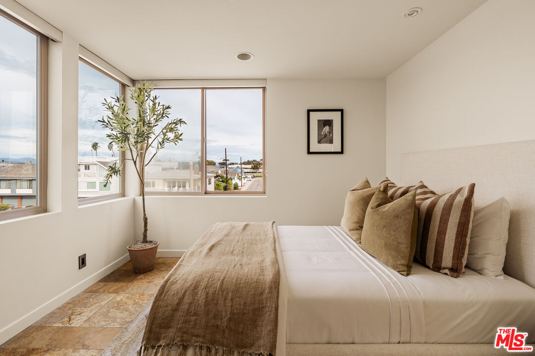 1825 Ocean Drive Oxnard, CA 93035 - Photo 16 of 29 a bedroom with a large bed and a large window