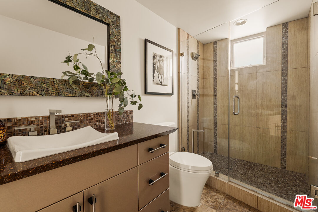 1825 Ocean Drive Oxnard, CA 93035 - Photo 17 of 29 a bathroom with a sink toilet a mirror and shower