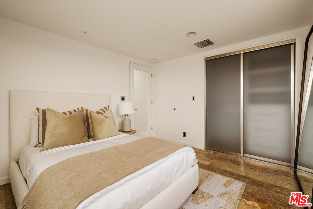 1825 Ocean Drive Oxnard, CA 93035 - Photo 19 of 29 a bedroom with a bed and a painting on the wall