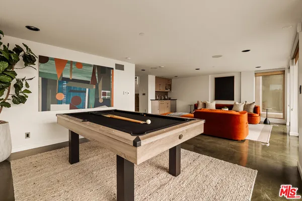a living room with a table and a flat screen tv