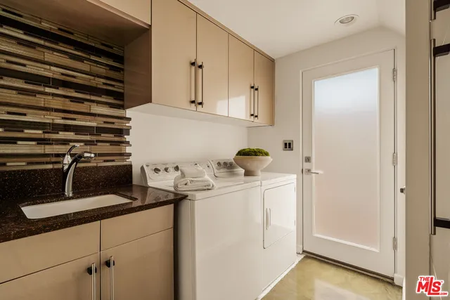 a kitchen with a refrigerator and white cabinets