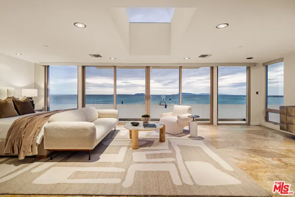 a spacious bedroom with a bed and large window