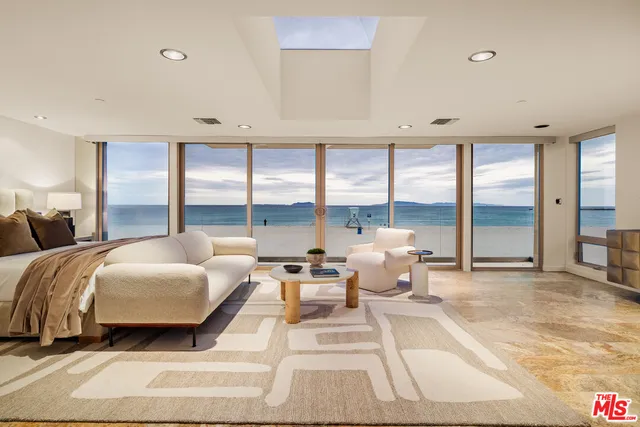 a spacious bedroom with a bed and large window