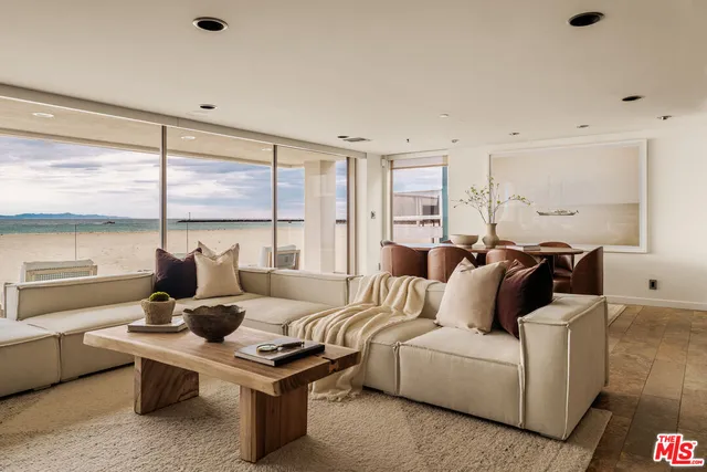 a living room with furniture wooden floor and a large window