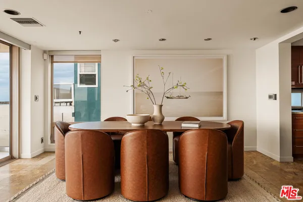 a room with stainless steel appliances wooden floor and large window