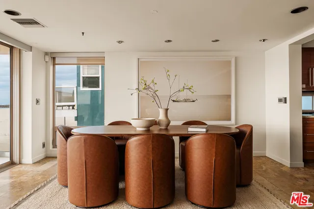 a room with stainless steel appliances wooden floor and large window