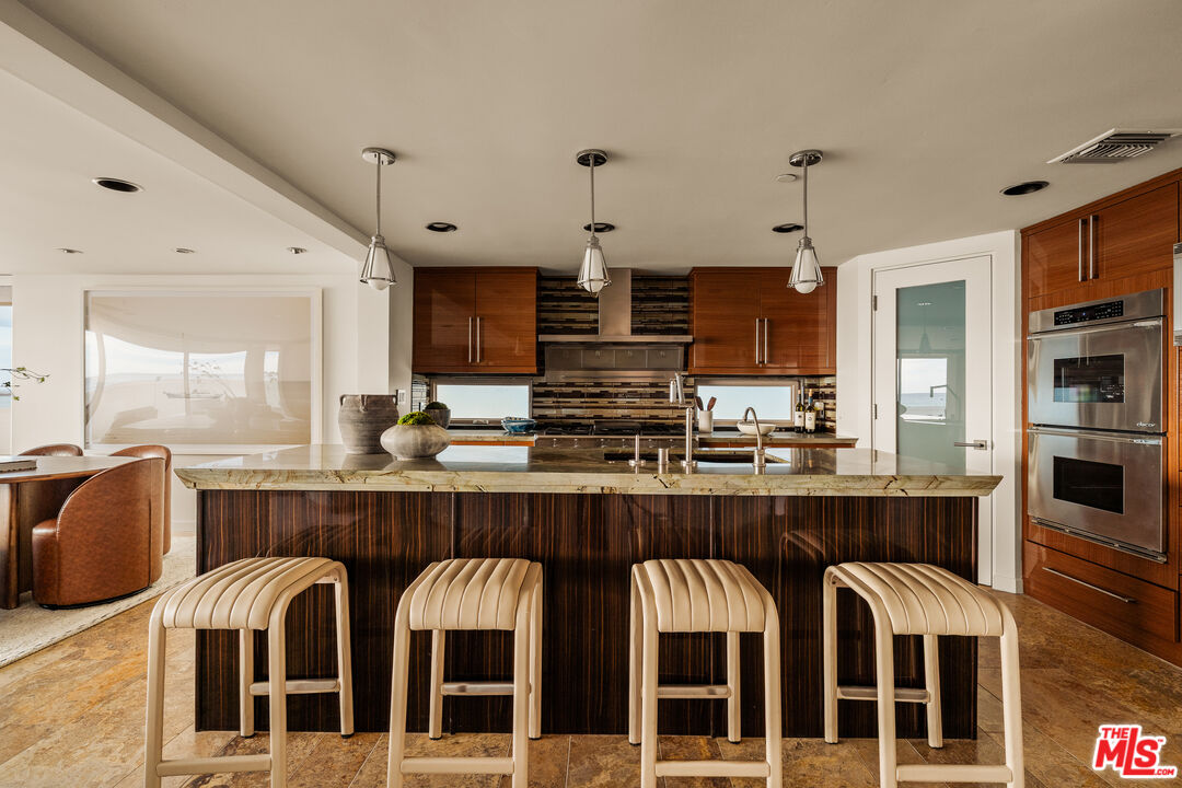 1825 Ocean Drive Oxnard, CA 93035 - Photo 7 of 29 a kitchen with stainless steel appliances granite countertop a stove and cabinets