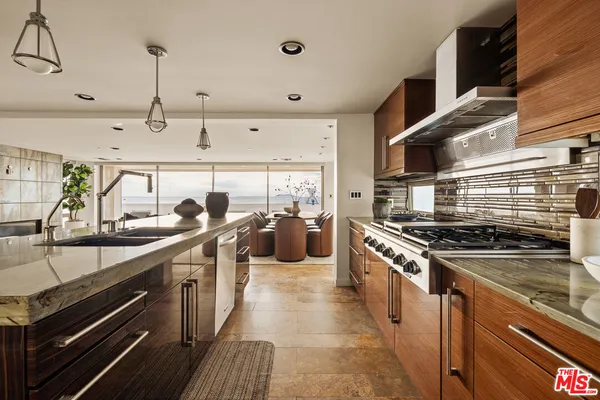 a kitchen with stainless steel appliances a sink stove and cabinets